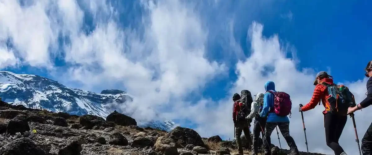 Preparation and safety equipment for climbing Kilimanjaro, including hiking boots, backpack, and warm clothing.