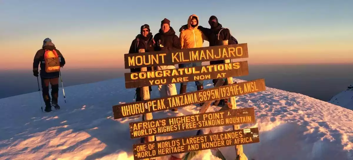 Kilimanjaro Mountain Triumph: Climbers at Uhuru Peak with JM Tours